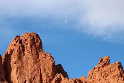 Low angle view of rock formation against sky