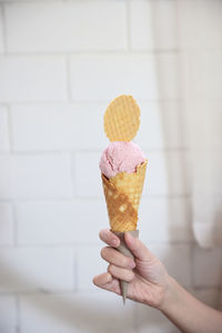 Cropped hand holding ice cream cone