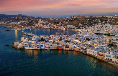 High angle view of townscape by sea against sky