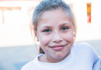 Beautiful blond girl with green eyes smiling