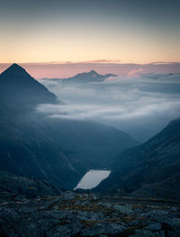 Scenic view of snowcapped mountains against sky during sunset