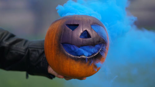 Close-up of hand holding jack o lantern