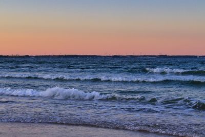 Scenic view of sea against clear sky during sunset