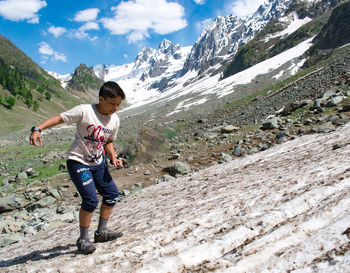 Rear view of man walking on mountain