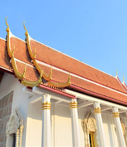 Low angle view of ornate building against clear blue sky