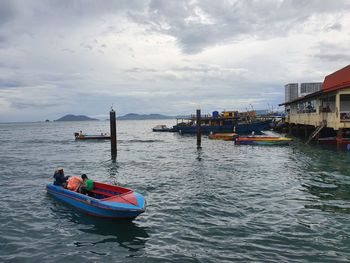 Boat moored on sea against sky