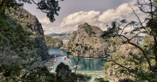 Panoramic view of lake and trees against sky