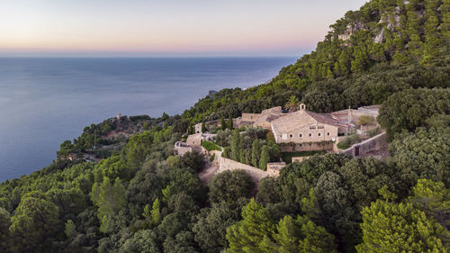 High angle view of buildings by sea against sky