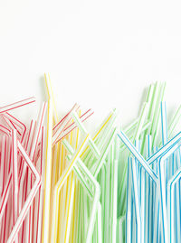 Close-up of multi colored pencils over white background