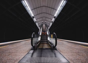 Portrait of young man sitting on subway station escalator