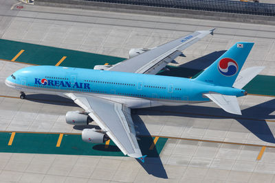 High angle view of airplane at airport runway