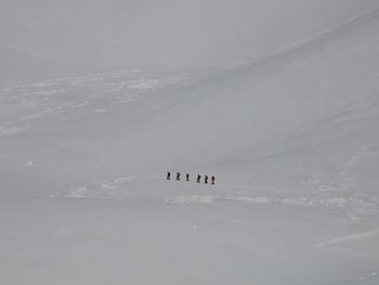 The climbers are in the snow desert, scenic view of snow covered mountain