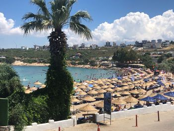 Scenic view of town by sea against sky