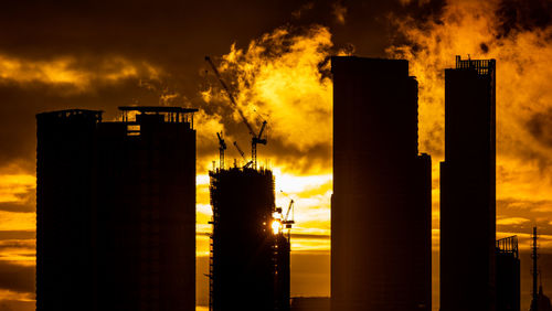 Smoke emitting from chimney against sky during sunset