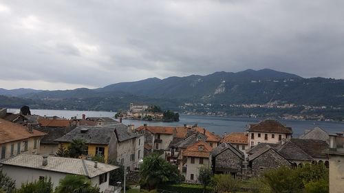 High angle view of townscape by mountain against sky