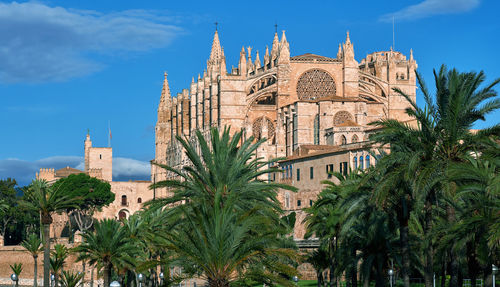 Panoramic view of trees and building against sky