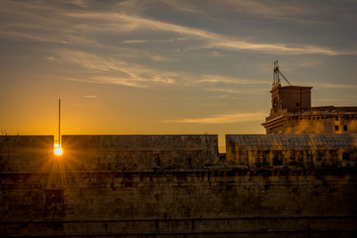 Building against sky during sunset