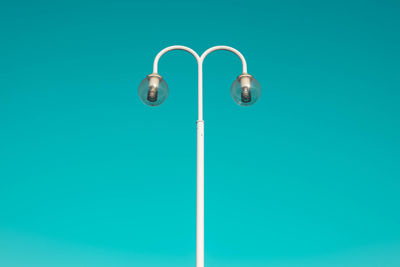 Close-up of electric lamp against blue background