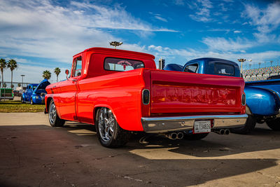 Vintage car parked on street against blue sky