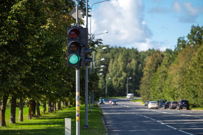 Closeup of traffic semaphore with green light on defocused city street