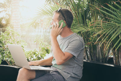 Full length of young man using mobile phone