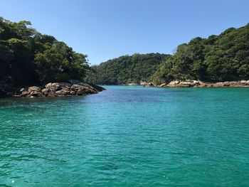 Scenic view of sea against clear blue sky