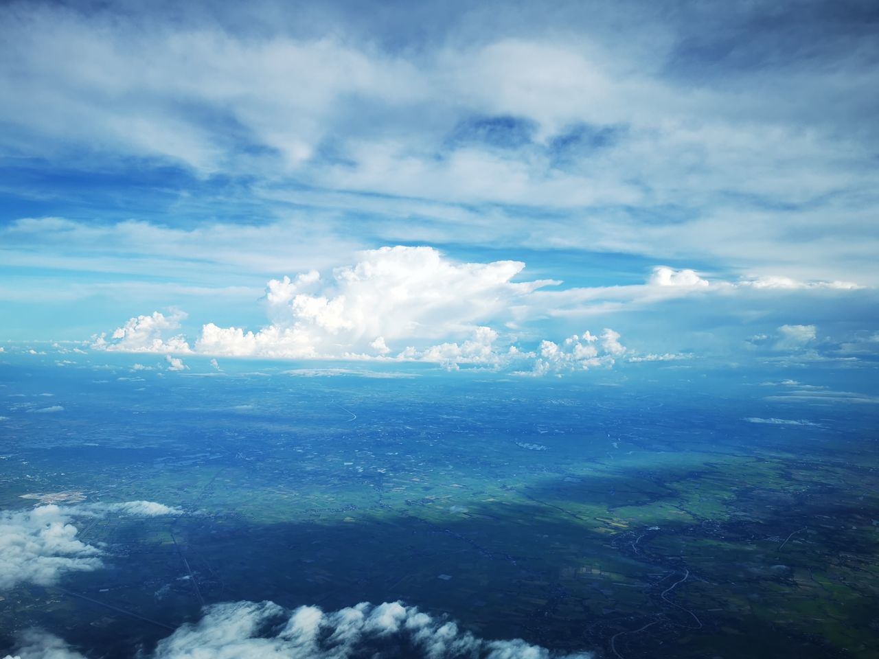 sky, cloud, horizon, environment, scenics - nature, nature, landscape, beauty in nature, aerial view, cloudscape, blue, sea, water, no people, tranquility, outdoors, sunlight, travel, day, mountain, land, ocean, tranquil scene, idyllic, plain, high up, airplane, backgrounds, overcast, dramatic sky, high angle view, wind, mountain range