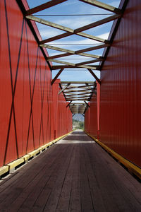 Empty road leading towards building