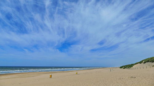 Scenic view of beach against blue sky