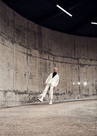 Man standing on wall of building