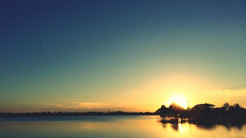 Scenic view of lake against sky during sunset