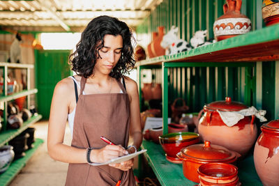 Midsection of woman holding food while standing on table