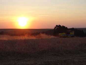 Scenic view of field against sky during sunset