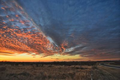 Scenic view of field against sky during sunset