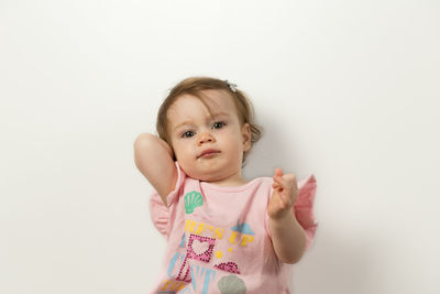 Portrait of cute girl against white background