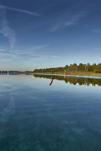 Scenic view of lake against blue sky