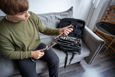 Rear view of boy playing piano
