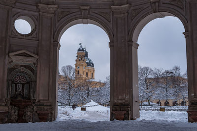 Cathedral in city seen through doorway during winter