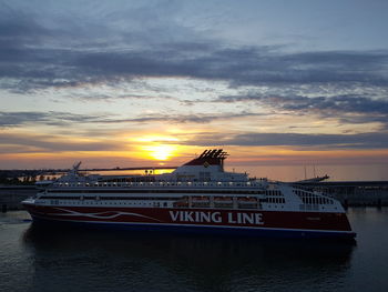 Ship moored on sea against sky during sunset