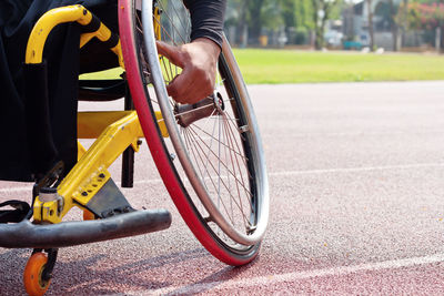 Cropped image of man on broken wheelchair