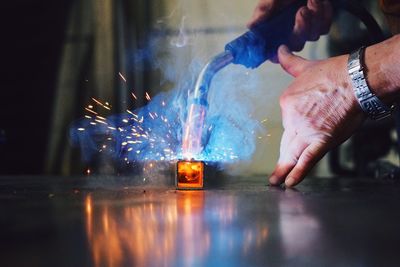 Close-up of man welding metal at workshop