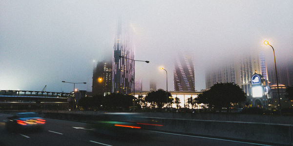 Illuminated city against sky