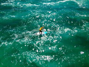 High angle view of man paddleboarding at sea