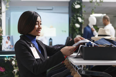 Side view of businesswoman using laptop at office