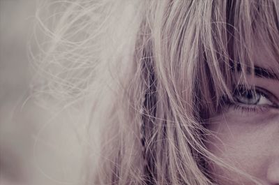 Cropped young woman with blue eye and blonde hair