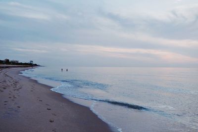 Scenic view of beach against sky during sunset