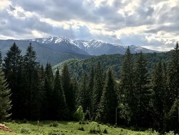 Scenic view of mountains against cloudy sky