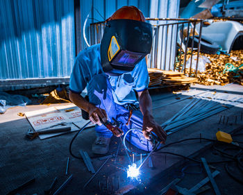 Welder at work in factory