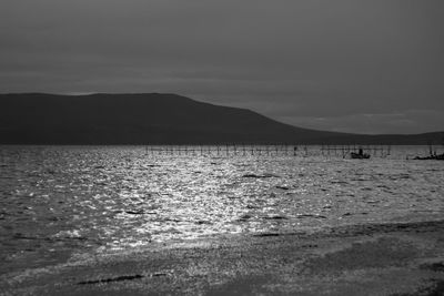 View of beach against cloudy sky