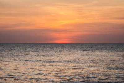 Scenic view of sea against orange sky